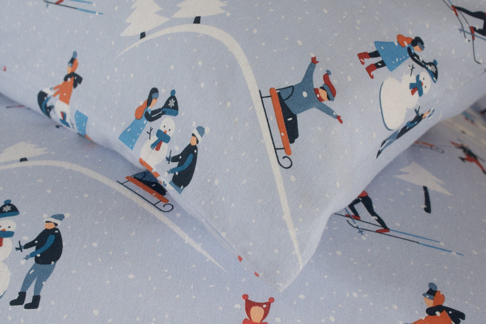 The Lyndon Company Fun Day brushed cotton duvet set with skiers and sledgers on pale blue