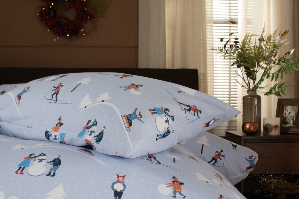 The Lyndon Company Fun Day brushed cotton duvet set with skiers and sledgers on pale blue