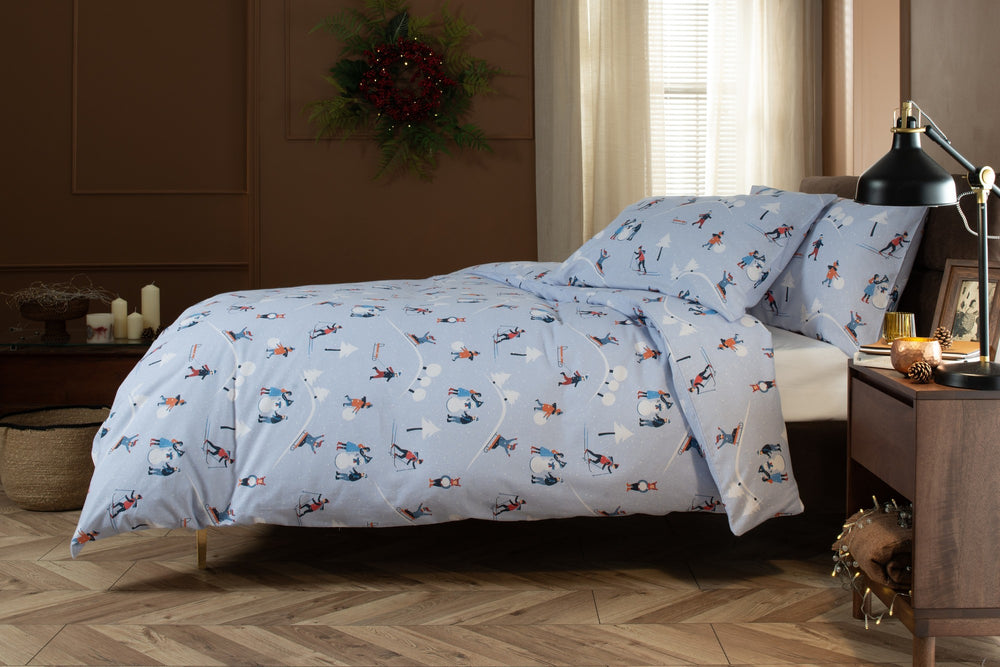 The Lyndon Company Fun Day brushed cotton duvet set with skiers and sledgers on pale blue