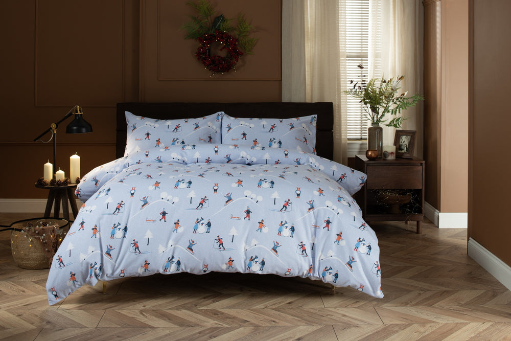 The Lyndon Company Fun Day brushed cotton duvet set with skiers and sledgers on pale blue